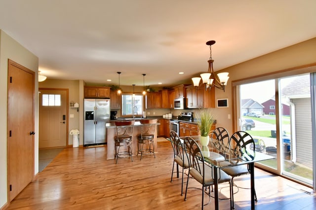 1756 34th St NE, Sauk Rapids, MN 56379 - dining space featuring healthy amount of natural light, light wood finished floors, a chandelier, and recessed lighting