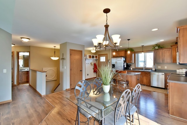 1756 34th St NE, Sauk Rapids, MN 56379 - dining space featuring light wood-style floors, a chandelier, recessed lighting, and baseboards