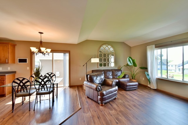 1756 34th St NE, Sauk Rapids, MN 56379 - living room with vaulted ceiling, wood finished floors, a chandelier, and baseboards