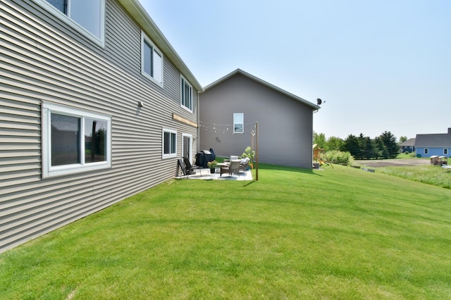 1756 34th St NE, Sauk Rapids, MN 56379 - back of house featuring a patio area and a lawn