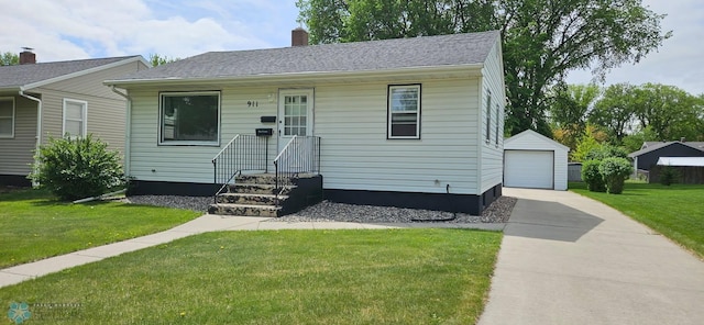 911 16th St N, Moorhead, MN 56560 - view of front of home with a garage, a front yard, an outbuilding, and a chimney