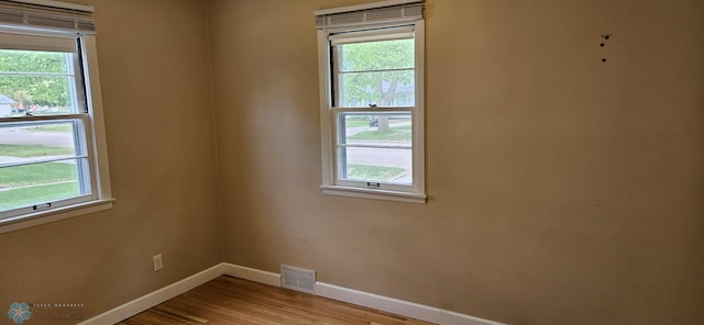 911 16th St N, Moorhead, MN 56560 - empty room featuring baseboards, wood finished floors, and healthy amount of natural light