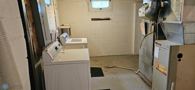 911 16th St N, Moorhead, MN 56560 - washroom featuring heating unit, washing machine and dryer, and concrete block wall