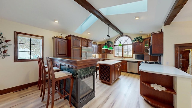 402 Main St, Racine, MN 55967 - kitchen featuring appliances with stainless steel finishes, a skylight, open shelves, light wood-style flooring, and recessed lighting