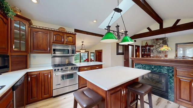 402 Main St, Racine, MN 55967 - kitchen featuring stainless steel appliances, light wood-style floors, a kitchen bar, light countertops, and glass insert cabinets