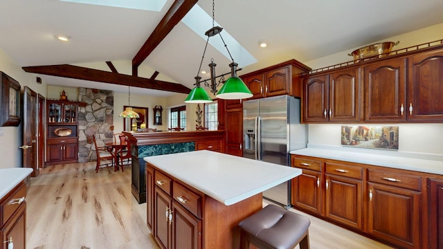 402 Main St, Racine, MN 55967 - kitchen with stainless steel refrigerator with ice dispenser, light wood-type flooring, light countertops, and hanging light fixtures