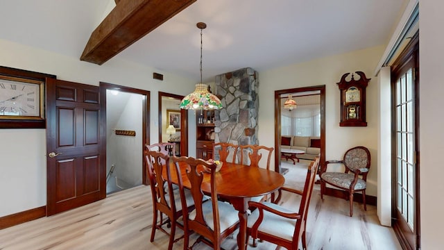 402 Main St, Racine, MN 55967 - dining room with light wood-style flooring, plenty of natural light, beam ceiling, and baseboards