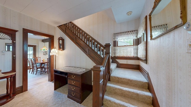 402 Main St, Racine, MN 55967 - staircase with wallpapered walls, carpet, and baseboards