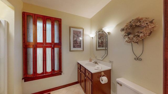 402 Main St, Racine, MN 55967 - half bath featuring toilet, vanity, tile patterned floors, and baseboards