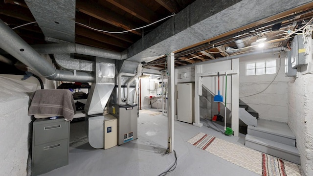 402 Main St, Racine, MN 55967 - below grade area with freestanding refrigerator, electric panel, and heating unit
