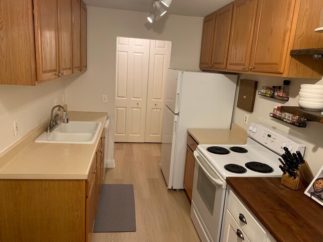 2800 Hillsboro Ave N Unit 316, New Hope, MN 55427 - kitchen with white appliances, a sink, light wood-type flooring, and brown cabinetry