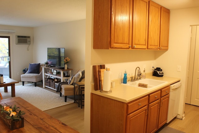 2800 Hillsboro Ave N Unit 316, New Hope, MN 55427 - kitchen featuring dishwasher, a sink, light wood-style flooring, and a wall mounted air conditioner