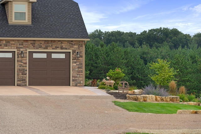 6339 140th Ave SE, Clear Lake, MN 55319 - view of property exterior with stone siding, driveway, and roof with shingles