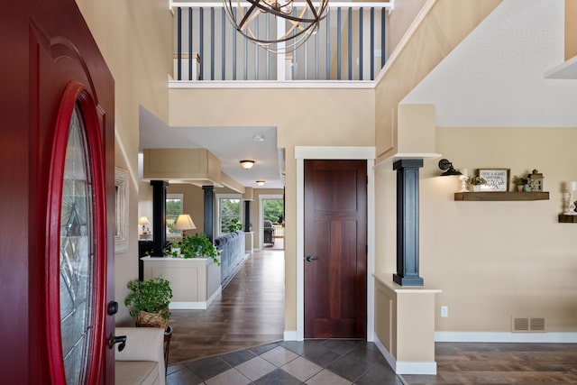 6339 140th Ave SE, Clear Lake, MN 55319 - tiled entryway with decorative columns, a towering ceiling, and a chandelier