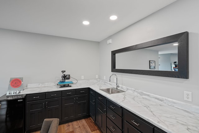6339 140th Ave SE, Clear Lake, MN 55319 - kitchen with dark cabinetry, recessed lighting, light wood-style flooring, and light stone counters