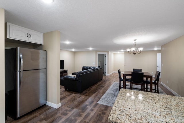 6339 140th Ave SE, Clear Lake, MN 55319 - dining space featuring dark wood-style floors and a chandelier