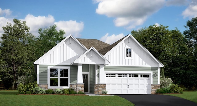 7665 Swan St, Lino Lakes, MN 55038 - view of front facade with board and batten siding, stone siding, asphalt driveway, a shingled roof, and a front yard