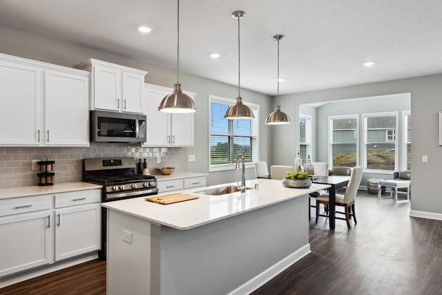 7665 Swan St, Lino Lakes, MN 55038 - kitchen with stainless steel appliances, dark wood finished floors, decorative backsplash, light countertops, and recessed lighting