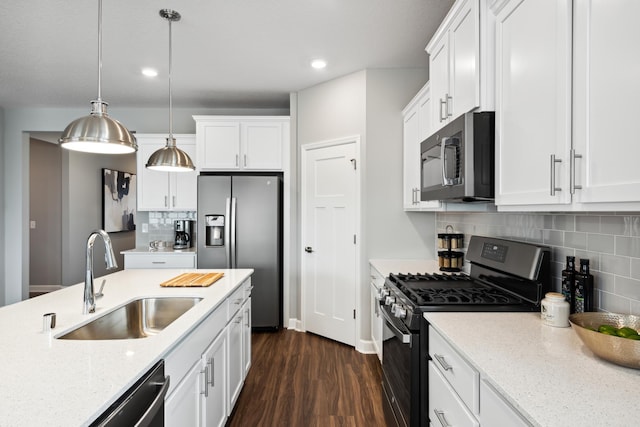 7665 Swan St, Lino Lakes, MN 55038 - kitchen with appliances with stainless steel finishes, recessed lighting, dark wood-style floors, white cabinetry, and hanging light fixtures