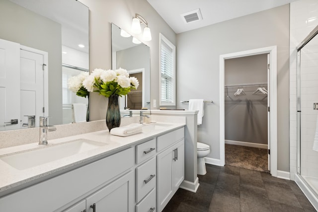 7665 Swan St, Lino Lakes, MN 55038 - bathroom featuring a shower stall, double vanity, and a walk in closet