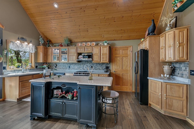 72959 235th St, Dassel, MN 55325 - kitchen with freestanding refrigerator, stainless steel microwave, vaulted ceiling, a center island with sink, and stove