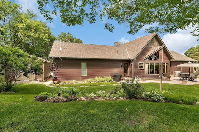 72959 235th St, Dassel, MN 55325 - back of house with a yard, a patio, roof with shingles, and a chimney