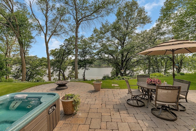 72959 235th St, Dassel, MN 55325 - view of patio featuring a water view, a hot tub, outdoor dining area, and an outdoor fire pit