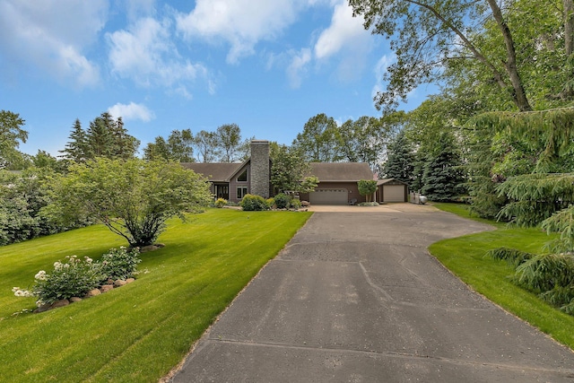 72959 235th St, Dassel, MN 55325 - view of front facade featuring an attached garage, a front yard, a chimney, and driveway