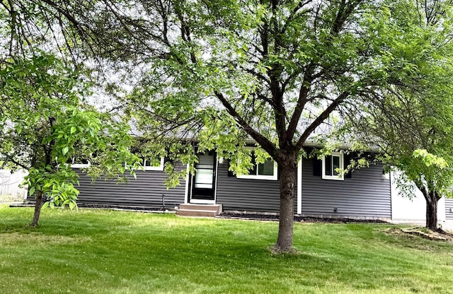 6092 Cougar Trl, North Branch, MN 55056 - rear view of house with entry steps and a lawn