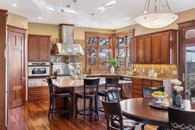 12159 Quail Avenue Ln N, Stillwater, MN 55082 - kitchen featuring a warming drawer, stainless steel oven, wall chimney range hood, dark wood-style floors, and a center island with sink