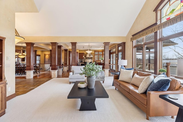 12159 Quail Avenue Ln N, Stillwater, MN 55082 - living area with ornate columns, a high ceiling, light carpet, and a chandelier