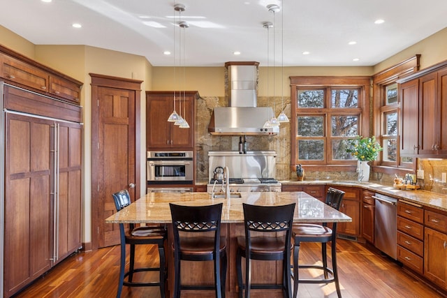 12159 Quail Avenue Ln N, Stillwater, MN 55082 - kitchen featuring appliances with stainless steel finishes, wall chimney exhaust hood, dark wood finished floors, backsplash, and light stone counters