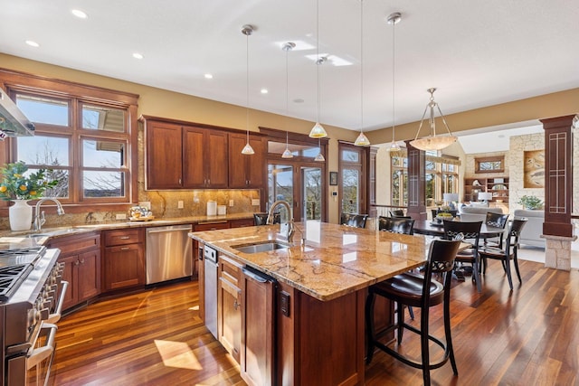 12159 Quail Avenue Ln N, Stillwater, MN 55082 - kitchen with appliances with stainless steel finishes, a sink, dark wood-type flooring, light stone countertops, and recessed lighting