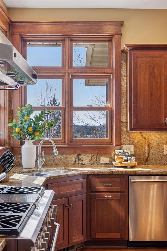12159 Quail Avenue Ln N, Stillwater, MN 55082 - kitchen featuring stainless steel dishwasher, a sink, extractor fan, stone counters, and brown cabinets