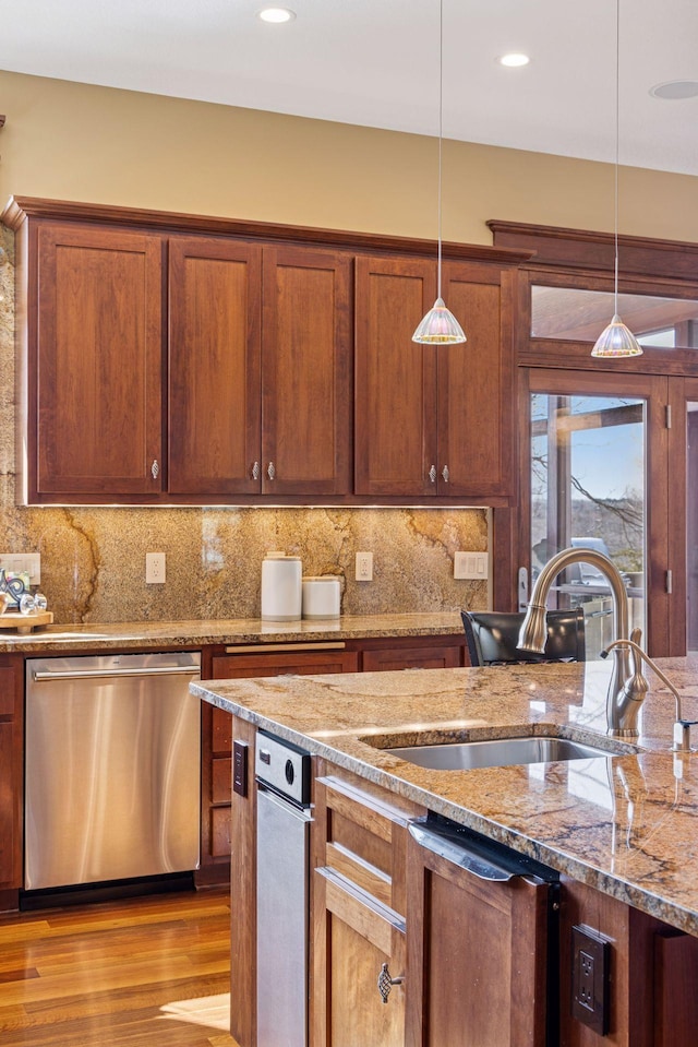 12159 Quail Avenue Ln N, Stillwater, MN 55082 - kitchen with stainless steel dishwasher, a sink, decorative light fixtures, wood finished floors, and recessed lighting