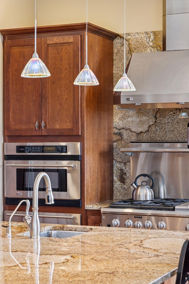 12159 Quail Avenue Ln N, Stillwater, MN 55082 - kitchen featuring stainless steel oven, decorative light fixtures, light stone counters, range, and decorative backsplash