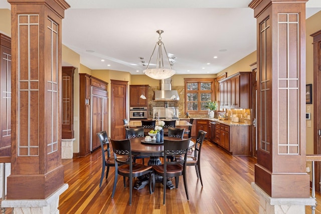 12159 Quail Avenue Ln N, Stillwater, MN 55082 - dining room featuring decorative columns, dark wood finished floors, and recessed lighting