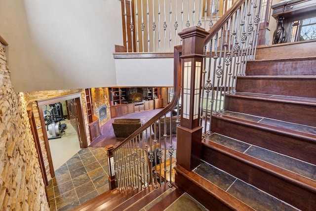 12159 Quail Avenue Ln N, Stillwater, MN 55082 - staircase featuring a fireplace and a high ceiling