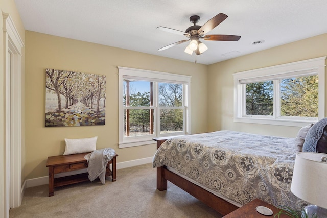 12159 Quail Avenue Ln N, Stillwater, MN 55082 - bedroom with light colored carpet, multiple windows, baseboards, and a ceiling fan