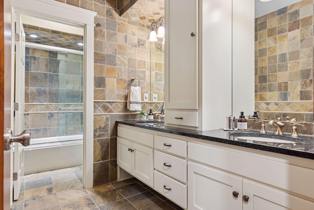 12159 Quail Avenue Ln N, Stillwater, MN 55082 - full bathroom featuring tile walls, double vanity, stone finish floors, and a shower