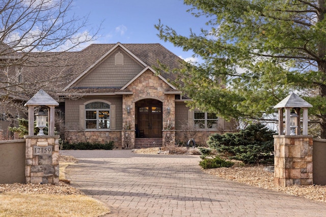 12159 Quail Avenue Ln N, Stillwater, MN 55082 - view of front facade featuring stone siding, a shingled roof, and decorative driveway