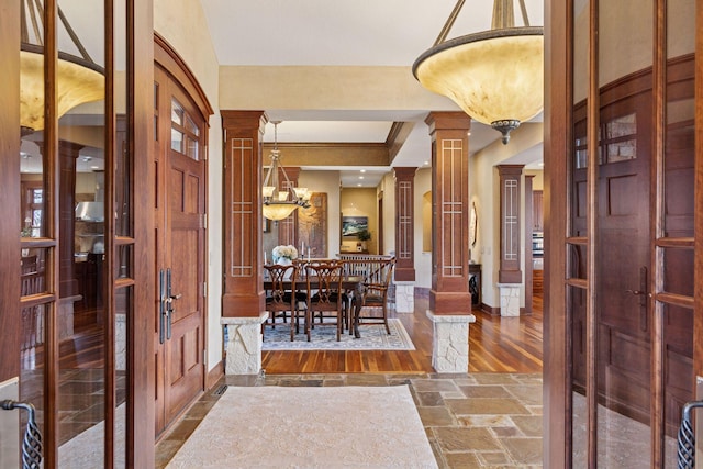 12159 Quail Avenue Ln N, Stillwater, MN 55082 - entryway with decorative columns, a chandelier, baseboards, stone tile floors, and crown molding
