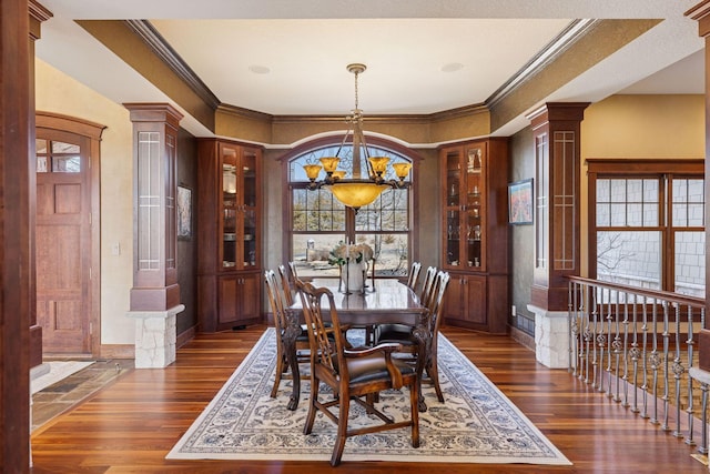 12159 Quail Avenue Ln N, Stillwater, MN 55082 - dining area featuring a chandelier, decorative columns, crown molding, and dark wood-style flooring