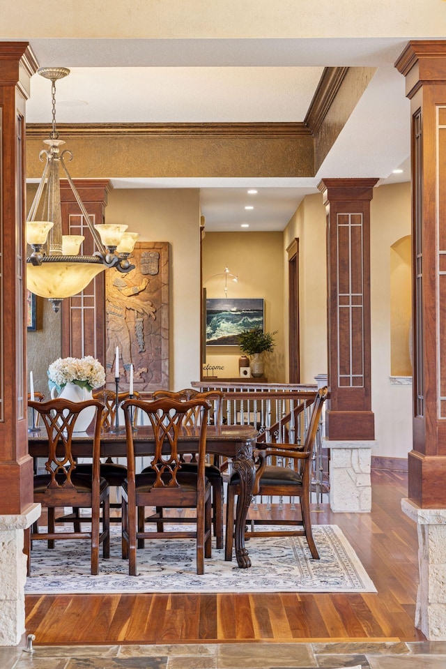 12159 Quail Avenue Ln N, Stillwater, MN 55082 - dining space featuring decorative columns, wood finished floors, ornamental molding, and a chandelier