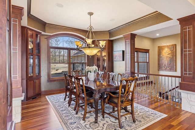 12159 Quail Avenue Ln N, Stillwater, MN 55082 - dining area with a chandelier, wood finished floors, crown molding, ornate columns, and baseboards