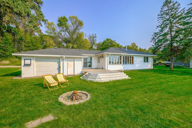 8549 Shore Trl N, Forest Lake, MN 55025 - rear view of property featuring a fire pit, a lawn, a deck, and a garage