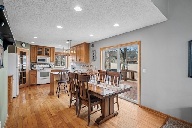 5392 Highland Trl, Big Lake, MN 55309 - dining room with a textured ceiling, light wood finished floors, recessed lighting, and baseboards