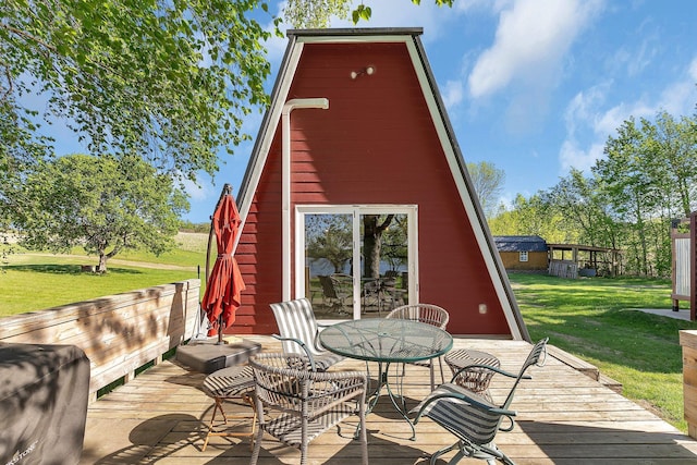 19663 County Road 9 NE, New London Twp, MN 56273 - wooden terrace featuring outdoor dining space and a lawn