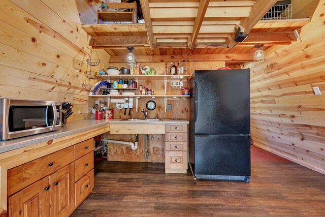 19663 County Road 9 NE, New London Twp, MN 56273 - kitchen featuring freestanding refrigerator, stainless steel microwave, wooden walls, dark wood-style flooring, and light countertops