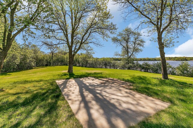 19663 County Road 9 NE, New London Twp, MN 56273 - view of home's community with a water view, a lawn, a patio area, and a wooded view